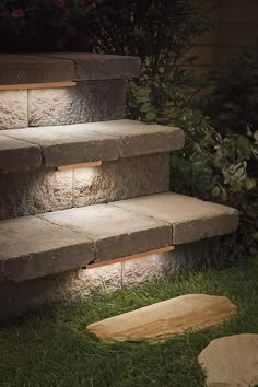 some steps lit up with lights in the grass