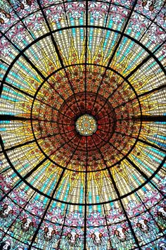 an ornate glass ceiling in the center of a building