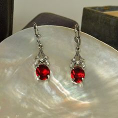 These breath-taking hand crafted earrings are the ultimate in antique style silver jewellery, with their vintage look and sparkling crystals. Inspired by Victorian designs, these drop earrings are made from only the highest quality Austrian crystals and sterling silver. Our wonderful matching silver pendant looks just beautiful worn with these earrings. The perfect gift for ruby wedding anniversaries or July birthdays. https://etsy.me/39J77b1 Sterling silver Hand made Highest quality Austrian cr Silver Oval Crystal Earrings For Wedding, Oval Sterling Silver Earrings For Evening, Antique Silver Jeweled Earrings, Silver Jeweled Sterling Silver Earrings, Elegant Jeweled Oval Earrings, Elegant Oval Jeweled Earrings, Oval Earrings With Sparkling Stones For Formal Occasions, Silver Oval Pendant Earrings For Anniversary, Formal Oval Earrings With Sparkling Stones