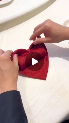 someone is making a heart out of felt