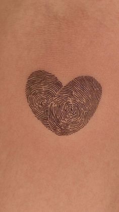 two fingerprints in the shape of a heart on someone's back shoulder