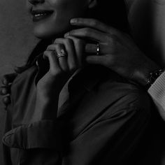 a man and woman holding each other's hands with rings on their fingers in front of them