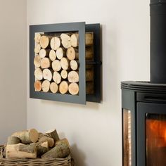 a fire place with logs in it next to a basket