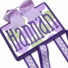 two purple and green name tags with bows on them