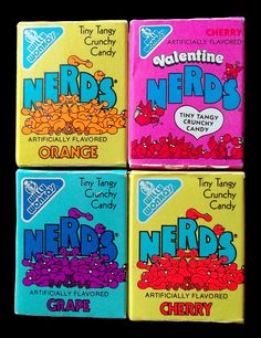 four boxes of nerds candy sitting on top of each other