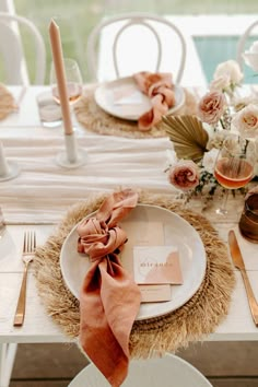 the table is set with plates, napkins and place settings for an elegant dinner