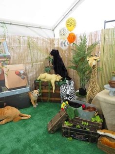 there are many stuffed animals on display in the room with green carpeted flooring