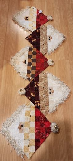 several pieces of fabric laid out on a wooden floor with holes in the middle to make them look like they have been made from old rugs