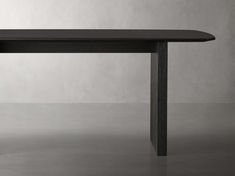 a black table sitting on top of a gray floor