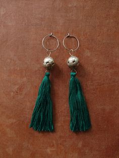 FLORES EARRINGS inspired by our trip to Guatemala. Simple, super lightweight earrings with vintage Guatemalan beads. Made from vintage handmade silver beads we found in Guatemala. Truly stunning and super lightweight (balls are empty inside).  The beads are rare finds.  Limited quantity. Adorned with Guatemalan embroidery thread tassels in lovely green shade. Anti-allergic surgical steel hoops.  approx 115mm PLEASE READ OUR SHIPPING POLICY Silver Latkan Tassel Drop Earrings, Silver Tassel Dangle Earrings, Silver Dangle Tassel Earrings With Latkans, Silver Tassel Earrings With Latkans For Gift, Silver Tassel Earrings With Latkans As Gift, Silver Bohemian Tassel Earrings With Dangling Beads, Handmade Silver Dangle Tassel Earrings, Silver Tassel Earrings For Festivals, Silver Tassel Earrings With Latkans For Party