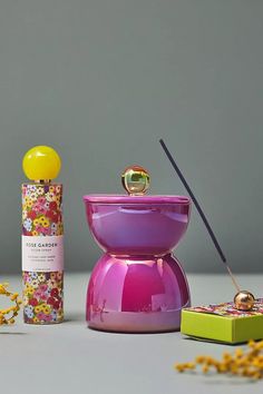 the colorful items are next to each other on the table, including a perfume bottle