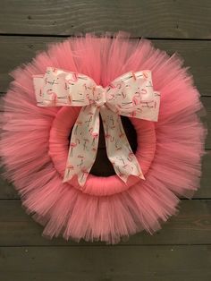 a pink tutule wreath with flamingos on it