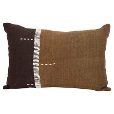 a brown and white pillow on a white background