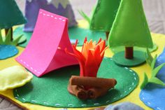 colorful paper trees are sitting on the ground