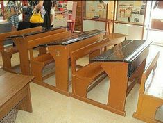 several wooden tables and benches in a room