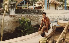 a man and child are sitting on a boat