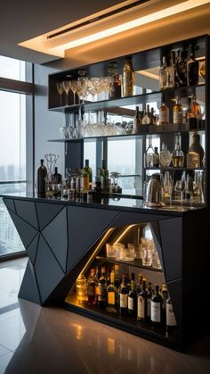 a bar with lots of bottles and glasses on the shelves in front of a large window