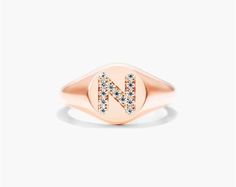 14K Rose Gold Diamond N Initial Signet Ring. This timeless ring will dazzle all who see it. Perfect for any age and occasion, this ring makes the perfect individualized gift! Luxury Rose Gold Engraved Promise Ring, Rose Gold Oval Initial Fine Jewelry Ring, Rose Gold Oval Initial Ring Fine Jewelry, Rose Gold Signet Ring With Vvs Clarity, Oval Rose Gold Initial Ring Fine Jewelry, Fine Jewelry Rose Gold Oval Initial Ring, Classic Rose Gold Signet Ring Vs Clarity, Hallmarked Oval Initial Ring In Rose Gold, Rose Gold Diamond Engraved Ring