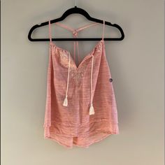 Never Been Worn Before With Tags! Abercrombie & Fitch Peach Tank Top With A White Design And Tassels In The Front. Crosses In The Back, And The Straps Are Adjustable. Size Medium. Summer Peach Blouse For The Beach, Summer Peach Blouse For Beach, Peach Summer Blouse For The Beach, Peach Summer Beach Blouse, Peach Blouse For Beach, Spring Season, Peach Blouse For Spring Beach Occasions, Peach Blouse For Beach In Spring, Feminine Peach Tops For The Beach, Feminine Peach Tops For Beach