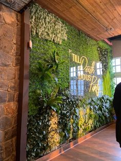 a man standing in front of a green wall with plants and words that read, truth about nature