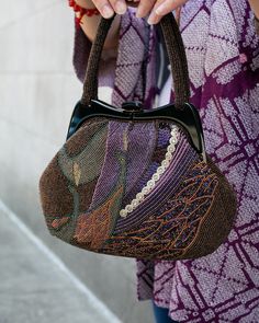 Our intricate, one of a kind vintage bags are estimated to have been produced between the 1970s–2000s. These bags are traditionally paired with kimonos as a luxurious statement piece. However, these versatile pieces may be dressed up or down with daily casual wear. Made in Japan Size: 9.5″ W x 7.5" H Product #: AC189 Code: NWS Retro Embroidered Evening Bags, Vintage Embellished Bag For Everyday Use, Vintage Embellished Bag As Fashion Accessory, Bohemian Handwoven Evening Bags, Vintage Embellished Bag, Brown Handwoven Evening Bag, Multicolor Bohemian Bags For Formal Occasions, Evening Handwoven Brown Bag, Evening Brown Handwoven Bag