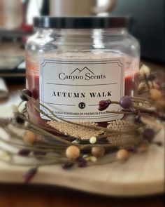 a jar filled with an autumn walk candle