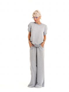 Take your athleisure looks to the next level. Our sweatsuit set combines the comfort of casual dressing with eye-catching streetwear elements for an elevated everyday look. FEATURES:A grey sweatsuit set with a pleated tulle panel at the back. The top has short puff-sleeves. The bottoms have an elastic waistband and functional side pockets.100% Handmade. SIZE & FIT: Fit: A relaxed fit with room to moveModel is wearing size Small or S/M View our SIZE CHART before ordering MATERIALS & CARE: Content: Viscose Care: Machine wash on cold (30ºC) with a mild detergent. SHIPPING: Made to order, processing time is 15 working days This item will be shipped via DHL