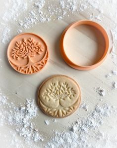 three cookie molds sitting next to each other on top of snow covered countertop