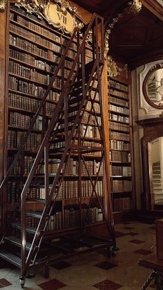 an old library with many bookshelves and clock on the wall next to it