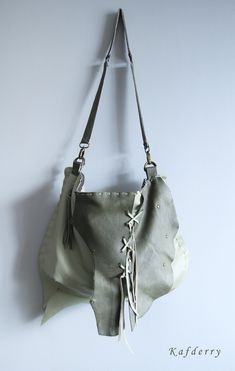 This bohemian bag is made of genuine  leather in light and dark olive green tones. I use fringe details.  There are 2 pockets inside and one of them is zippered. All sewings are handmade  carefully.  Its  width is 44 and height is 32 cm. Thickness is 8 cm. (17'' x12,5'' x 3'' ) Please note that color may vary according to monitor color calibrations. If you have any question, please don't hesitate me to ask whatever you want know. Bohemian Leather Hobo Bag With Tassels, Leather Hobo Bag With Tassels, Leather Hobo Shoulder Bag With Tassels, Leather Hobo Bag With Tassels In Tote Shape, Bohemian Leather Bag With Tassels, Leather Fringe Hobo Bag For Daily Use, Leather Shoulder Bag With Fringe For Daily Use, Daily Use Leather Hobo Bag With Fringe, Leather Hobo Bag With Tassels In Crossbody Style