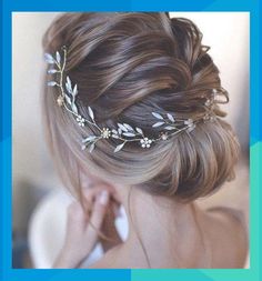 a woman wearing a wedding hair piece with flowers and leaves on it's head