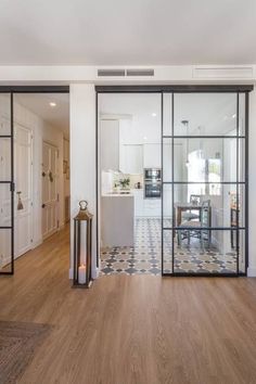 an open living room and dining area with sliding glass doors that lead into the kitchen