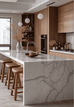 a kitchen with marble counter tops and wooden stools