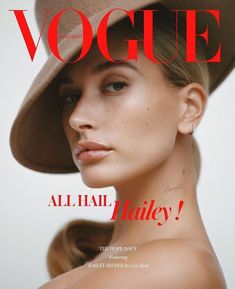 a woman wearing a tan hat on the cover of a magazine, with her face close to the camera