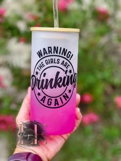 a person holding up a pink drink with a straw in it's mouth and the words drinking again on it