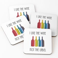 four coasters with different colored wine bottles on the top one has i like the wine, not the label