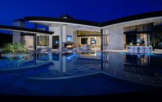 a large house with a swimming pool at night