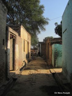 an alley way with buildings and trees in the background