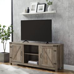 an entertainment center with a large flat screen tv