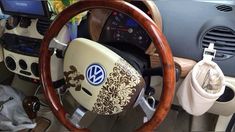 the steering wheel and dashboard of a car with wood trimmings, decorated with floral designs