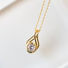 There is nothing quite as elegant as a solitaire drop Cubic Zirconia crystal pendant necklace. This Golden beauty features a shiny diamond-like crystal hung on a delicate chain. Gold Vermeil Cubic Zirconia pave crystal Hypoallergenic, lead and nickel free Pendant: 0.75 inch (1.9 cm) x Width 0.4 inch (1 cm) Chain length 18 inch (45.7 cm)+ 2in (5cm) extension #N314 Diamond Pendants Designs, Beauty Features, Diamond Pendants, Crystal Pendant Necklace, Drop Pendant Necklace, Delicate Chain, Solitaire Pendant, Chain Gold, Crystal Necklace Pendant