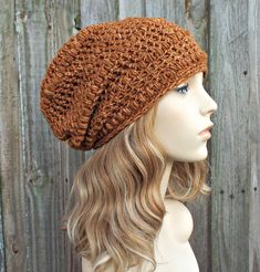 "Style: Slouchy crochet hat. Color: This sample hat is shown in \"Top stitch\", the orange stitching color you see on blue jeans. Sizes: One size fits average teen or adult head size of 20\" to 23\" (50.5 cm to 58 cm). Fiber Content: 100% acrylic Characteristics: Very soft, bohemian and cozy. Care Instructions: Hand wash, dry flat. Every item from Pixiebell is handmade and knit or crocheted to order, unless otherwise stated in title of the item as \"ready to ship\". Production time may vary, ple Puff Stitch Beanie, Hats Outfit, Bonnet Au Crochet, Orange Beanie, Crochet Bonnet, Fall Fashion Accessories, Crochet Hood, Crochet Slouchy Hat, Orange Hat