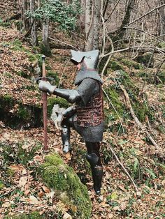 a statue of a knight in the woods