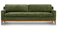 a green couch sitting on top of a wooden frame