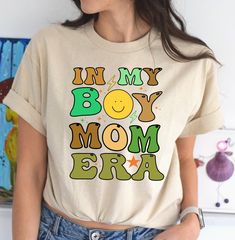 Welcome to the In My Boy Mom Era Shirt! As a proud boy mom, we understand the joy and chaos that comes with raising energetic little gentlemen. Our stylish and comfortable shirt is the perfect way to celebrate your journey in this boy mom era. Made with high-quality materials, this shirt features a trendy design that showcases your love for being a boy mom. Wear it proudly and let the world know that you're rocking the boy mom life. Whether you're running errands, attending school functions, or just enjoying quality time with your boys, this shirt is a must-have addition to your wardrobe. Get yours today and embrace the beauty of being a boy mom!   OUR RANGE OF T-SHIRTS: ✔Original Designs: We pride ourselves on offering unique designs, created by our talented team of artists. From bold pat Fall Boy Mom Shirt, Boy Mom Shirt, Mom Of Boys Shirt, Expecting Mom Gifts, Mom Era, Moms Club, New Mom Gift, My Boy, Mom Sweatshirt