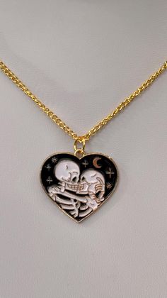 Skeleton Lovers in a heart shaped pendant with gold accents.  Crescent moon and stars also on this striking pendant.   Gold plated chain is approximately 18 inches long with lobster claw clasp.  If you would like a longer or shorter chain, please message me. Skeleton Lovers, Skeleton Love, Skeleton Necklace, Stationary Supplies, Heart Shaped Pendant, Love Jewelry, Heart Shape Pendant, Moon And Stars, Pendant Gold