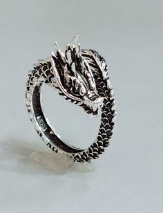 Discover the Awesome Style Retro Dragon Ring - a unique statement piece that is sure to turn heads. This intricately designed ring features a stylized dragon motif in a retro-inspired design, crafted from high-quality sterling silver. The intricate details of the dragon are exquisitely etched into the silver, giving the ring a striking yet elegant appearance. Overview: 100% new design and high quality Must-have for fashion women Have a beautiful appearance Specifications: Material: Copper Style: Goth Ring, Boyfriend Gifts Long Distance, Animal Zodiac, Peacock Ring, Ancient Dragon, Serpent Ring, X Ring, Vintage Dragon, Dragon Ring