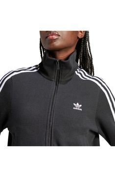 Made from a blend of cotton and recycled yarns, this ribbed track jacket with the 3-Stripes will keep you both comfy and sporty. Front zip closure Stand collar Front welt pockets 79% cotton, 21% recycled polyester Machine wash, dry flat Imported Spring Track Jacket With Three Stripes Branding, Sporty Ribbed Outerwear For Fall, Sporty Winter Track Jacket With Side Stripes, Winter Sportswear Track Jacket With Three Stripes, Sporty Track Jacket With Three Stripes For Fall, Sportswear Track Jacket With Ribbed Collar For Fall, Athleisure Track Jacket With Side Stripes For Winter, Winter Track Jacket With Three Stripes, Sporty Cotton Track Jacket For Fall