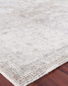 a white rug on top of a wooden floor