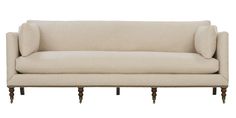 a white couch sitting on top of a wooden frame